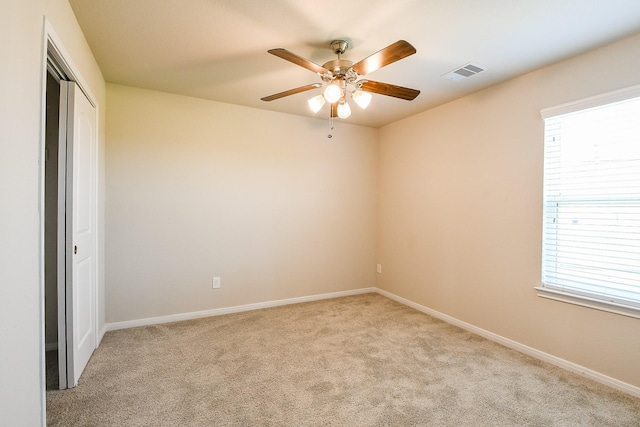 2103 Islawild Way, Texas City, TX 77568 - empty room with a ceiling fan, light colored carpet, and healthy amount of natural light