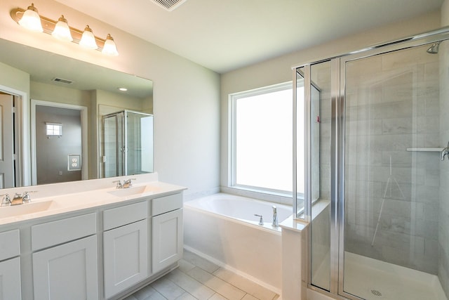 2103 Islawild Way, Texas City, TX 77568 - bathroom with a stall shower, double vanity, a bath, and tile patterned flooring