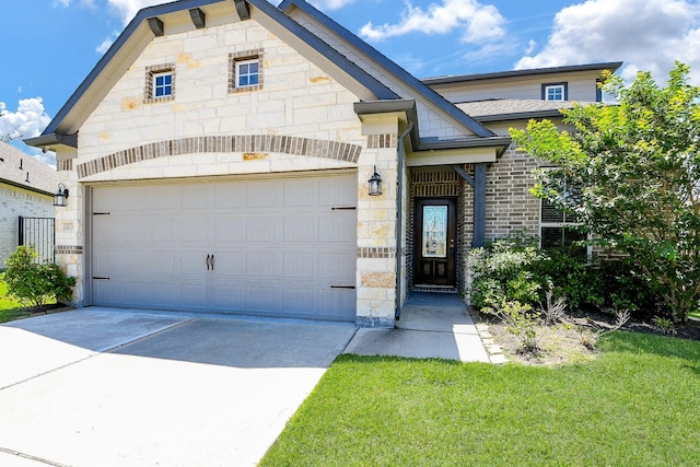 2103 Islawild Way, Texas City, TX 77568 - view of front of house with stone siding, concrete driveway, a front yard, and an attached garage