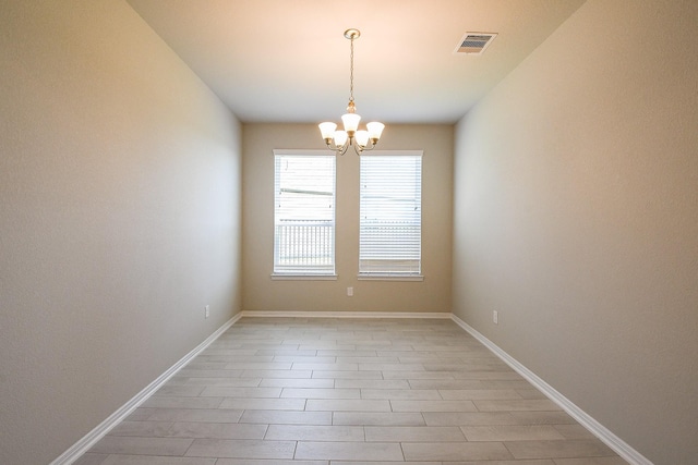 2103 Islawild Way, Texas City, TX 77568 - unfurnished room with a chandelier, baseboards, and light wood-type flooring
