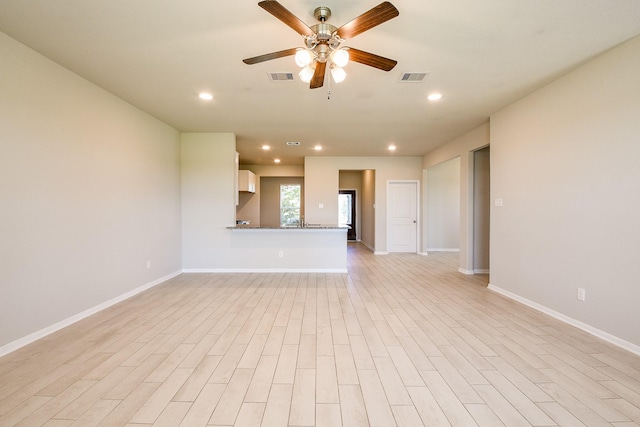 2103 Islawild Way, Texas City, TX 77568 - unfurnished living room featuring ceiling fan, baseboards, recessed lighting, and light wood-type flooring