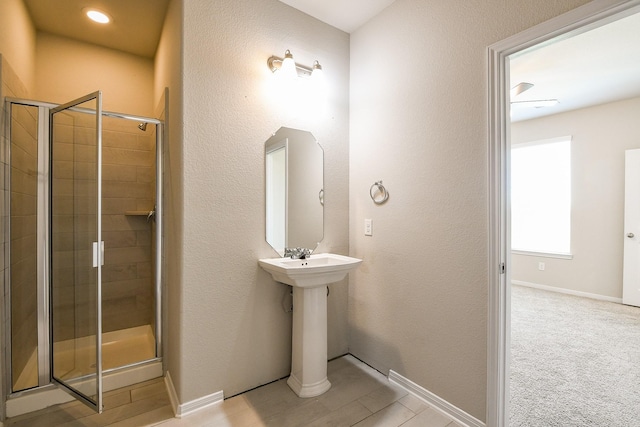 2103 Islawild Way, Texas City, TX 77568 - full bathroom featuring a shower stall, baseboards, and a textured wall
