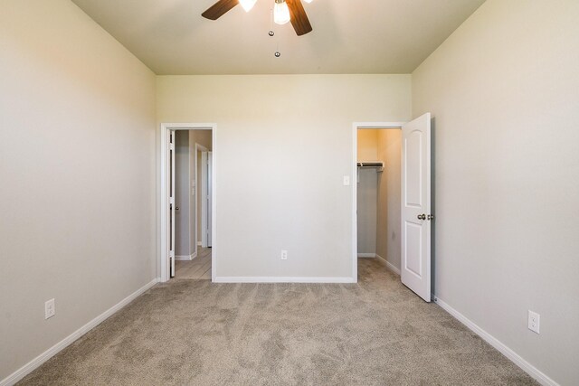 2103 Islawild Way, Texas City, TX 77568 - unfurnished bedroom with carpet floors, baseboards, a walk in closet, and ceiling fan