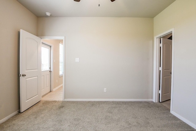 2103 Islawild Way, Texas City, TX 77568 - empty room featuring light colored carpet, a ceiling fan, and baseboards