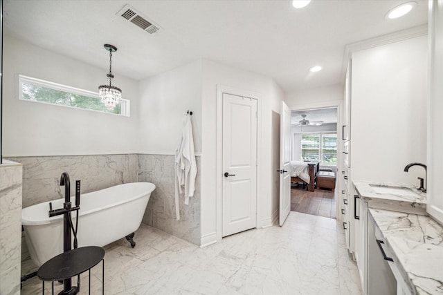 full bathroom with recessed lighting, a wainscoted wall, visible vents, ensuite bath, and a soaking tub