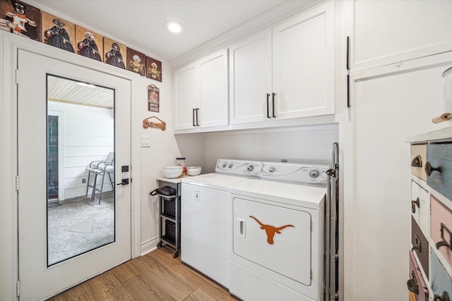 laundry area featuring washing machine and dryer, light wood-style flooring, cabinet space, and recessed lighting