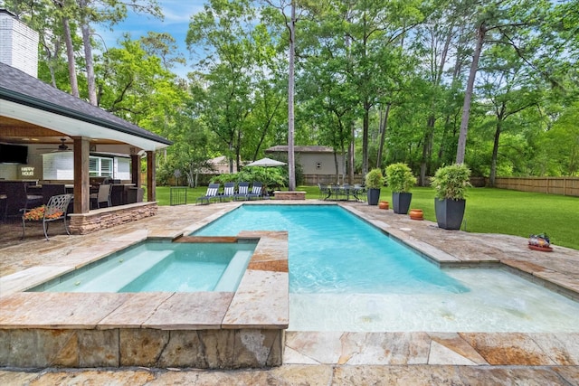 view of swimming pool featuring a patio area, a lawn, a ceiling fan, a fenced backyard, and outdoor dry bar