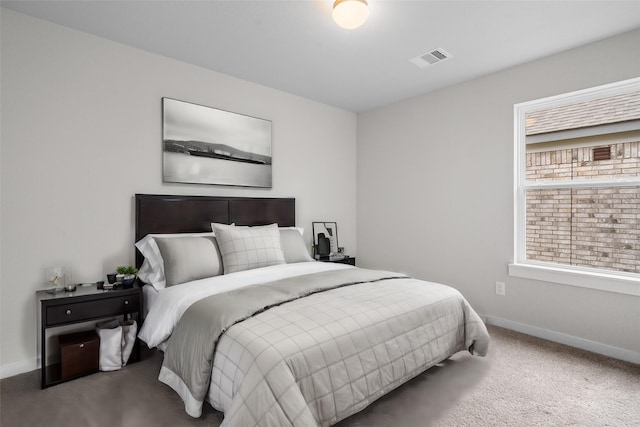 carpeted bedroom featuring visible vents and baseboards