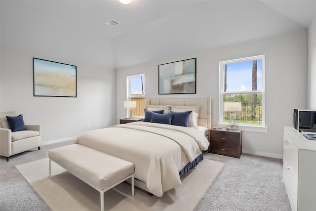 bedroom featuring baseboards, vaulted ceiling, visible vents, and light carpet