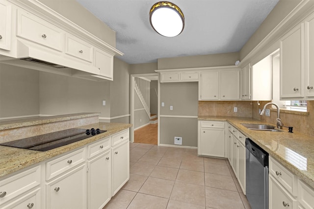 kitchen with stainless steel dishwasher, black electric stovetop, white cabinets, a sink, and light tile patterned floors