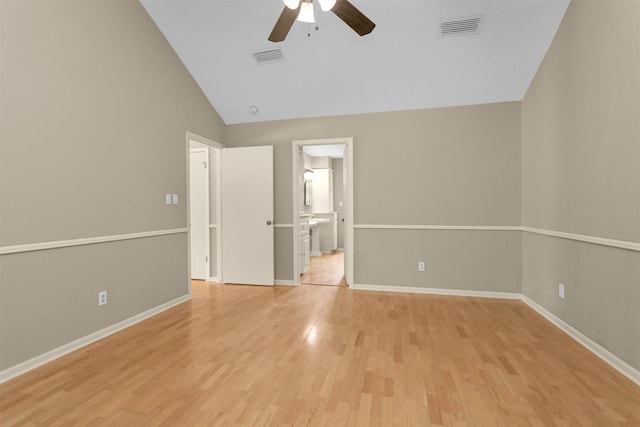 unfurnished bedroom with ceiling fan, visible vents, baseboards, lofted ceiling, and light wood-style floors