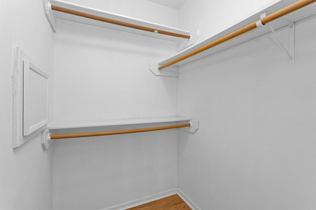 walk in closet featuring wood finished floors