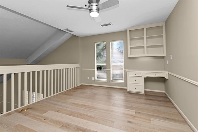 unfurnished office with ceiling fan, visible vents, light wood finished floors, and built in study area