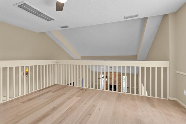 additional living space featuring ceiling fan, visible vents, and wood finished floors