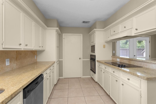 kitchen featuring light stone counters, white cabinets, black appliances, a peninsula, and light tile patterned flooring
