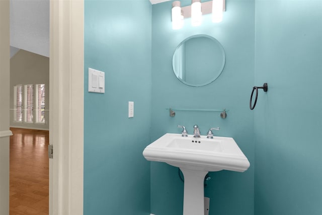 bathroom with a sink and wood finished floors