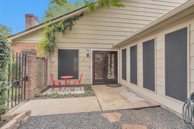 property entrance featuring french doors and a chimney