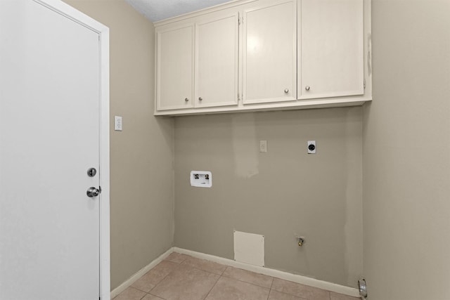 laundry room featuring electric dryer hookup, cabinet space, light tile patterned floors, baseboards, and hookup for a washing machine