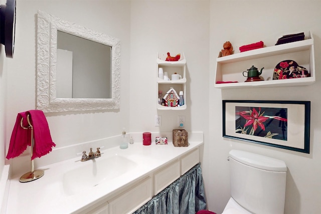 bathroom with toilet and vanity