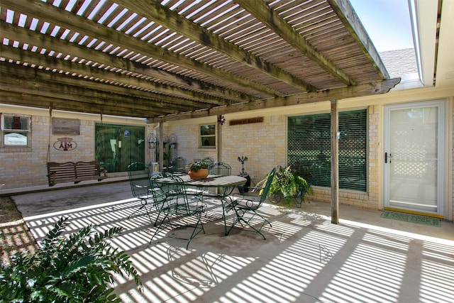 view of patio featuring a pergola and outdoor dining area