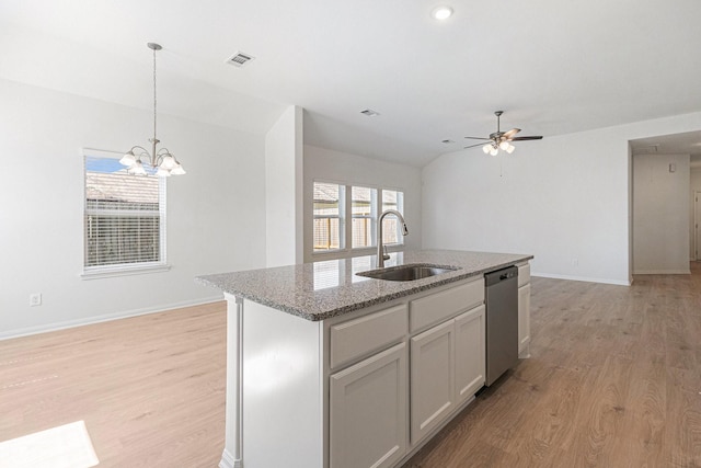 kitchen featuring dishwasher, light wood finished floors, baseboards, and a sink