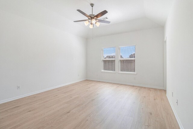 unfurnished room with light wood-type flooring, ceiling fan, baseboards, lofted ceiling, and visible vents