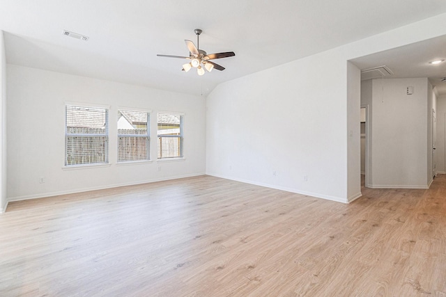 empty room featuring light wood finished floors, visible vents, baseboards, attic access, and ceiling fan
