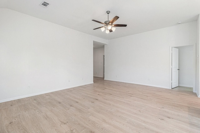 spare room with light wood-style flooring, visible vents, baseboards, and ceiling fan