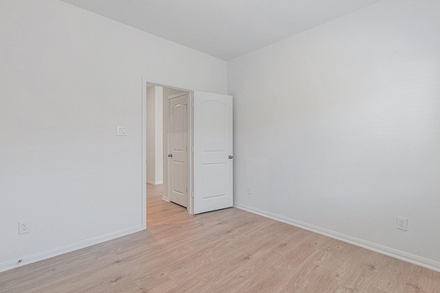 unfurnished room featuring light wood-style floors and baseboards