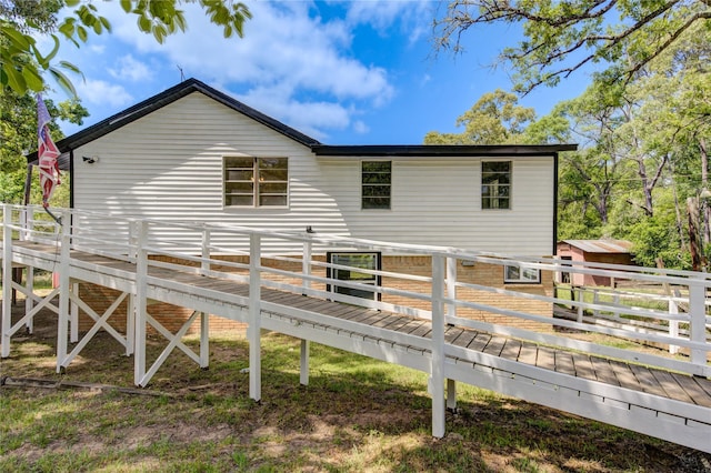 back of house featuring a deck
