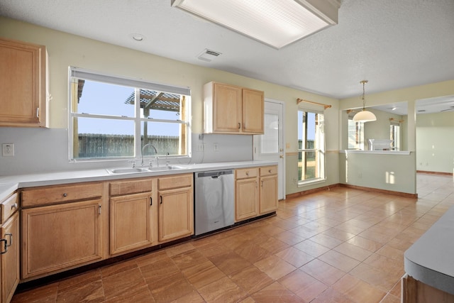 kitchen with stainless steel dishwasher, a sink, light countertops, decorative light fixtures, and visible vents