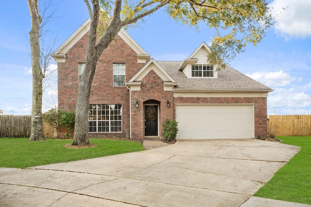 traditional-style house featuring a front lawn, brick siding, fence, and driveway