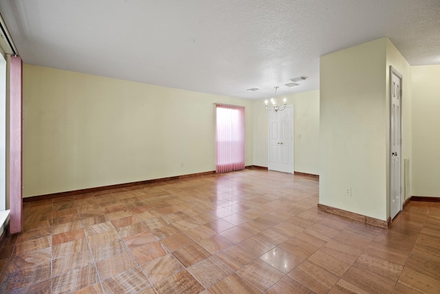 unfurnished room featuring a textured ceiling, tile patterned floors, a chandelier, baseboards, and visible vents