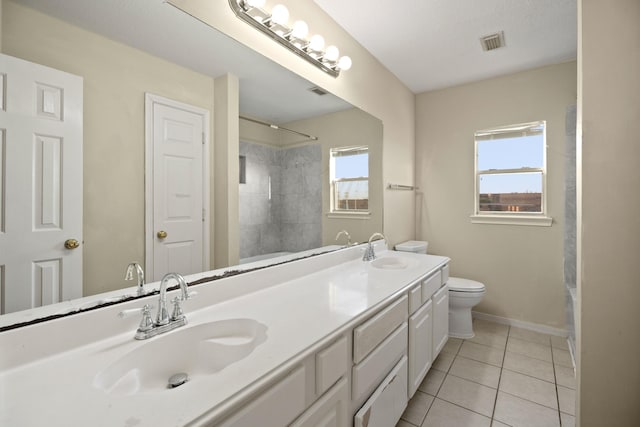 full bathroom with a wealth of natural light, visible vents, and a sink