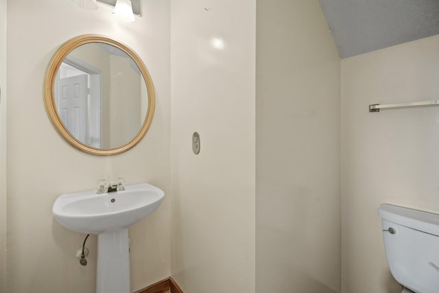 bathroom featuring toilet and a sink