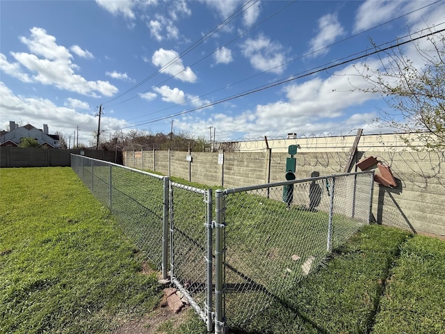 view of yard featuring fence and a gate
