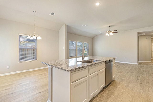 kitchen with baseboards, stainless steel dishwasher, a sink, and light wood-style floors