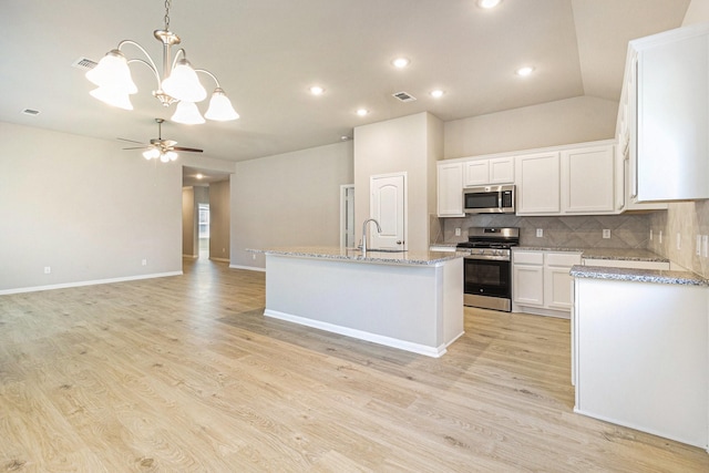 kitchen featuring white cabinets, visible vents, light wood-style floors, backsplash, and appliances with stainless steel finishes