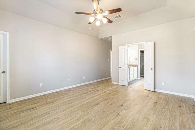 unfurnished bedroom featuring light wood-style floors, visible vents, baseboards, and connected bathroom