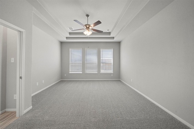 5319 Costa Ridge Ln, Katy, TX 77493 - unfurnished room with ceiling fan, light carpet, a tray ceiling, baseboards, and visible vents