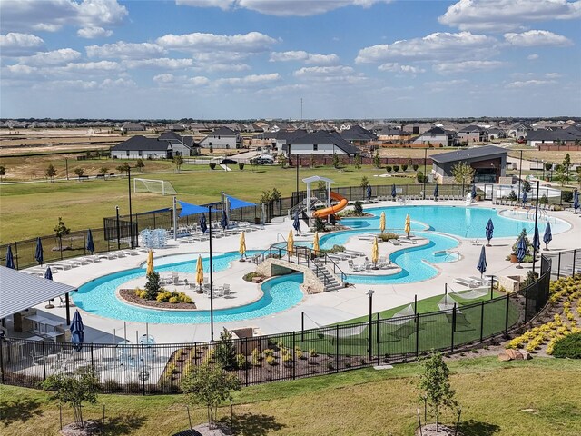 5319 Costa Ridge Ln, Katy, TX 77493 - community pool featuring a water play area, fence, a water slide, and a lawn