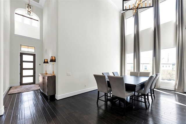111 Vetch Park Ct, Montgomery, TX 77316 - dining space with a high ceiling, a chandelier, baseboards, dark wood finished floors, and crown molding