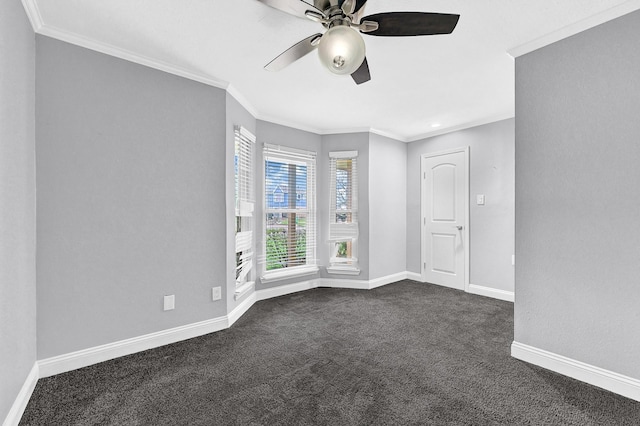 interior space featuring dark colored carpet, ornamental molding, baseboards, and ceiling fan