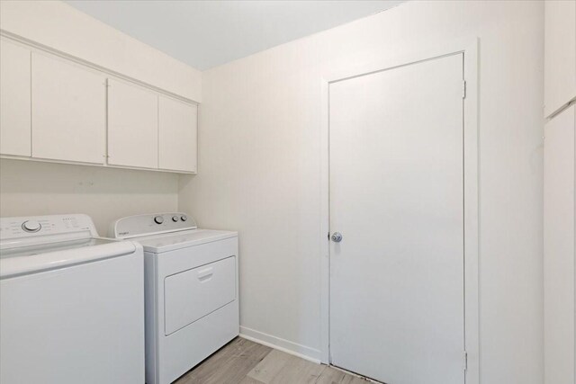 1330 Saxony Ln, Houston, TX 77058 - laundry room featuring cabinet space, light wood finished floors, and washer and dryer