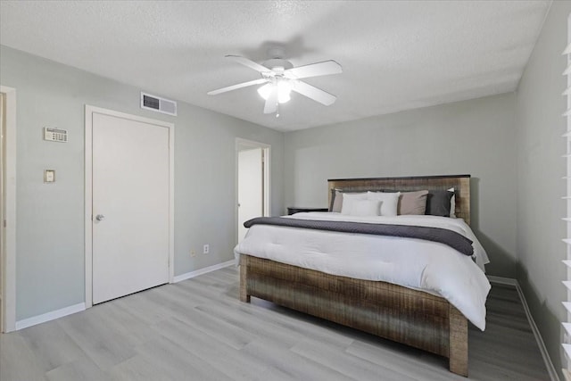 1330 Saxony Ln, Houston, TX 77058 - bedroom featuring wood finished floors, visible vents, a ceiling fan, and baseboards