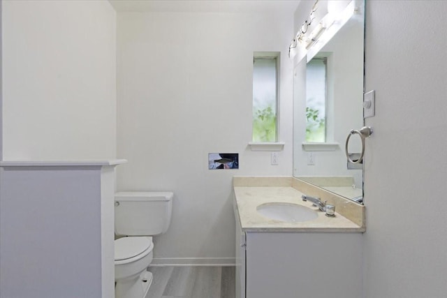 1330 Saxony Ln, Houston, TX 77058 - half bathroom featuring baseboards, wood finished floors, vanity, and toilet