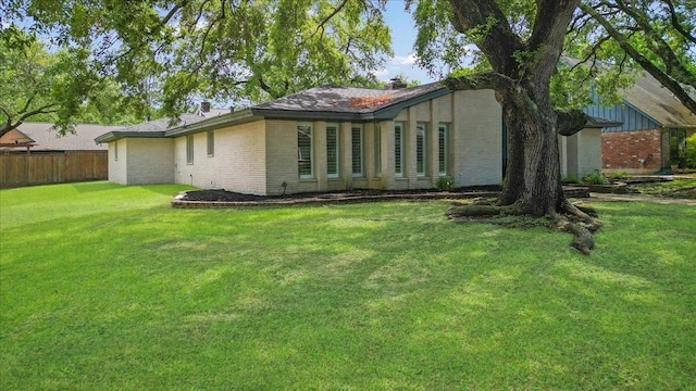 1330 Saxony Ln, Houston, TX 77058 - rear view of house with a lawn, brick siding, and fence