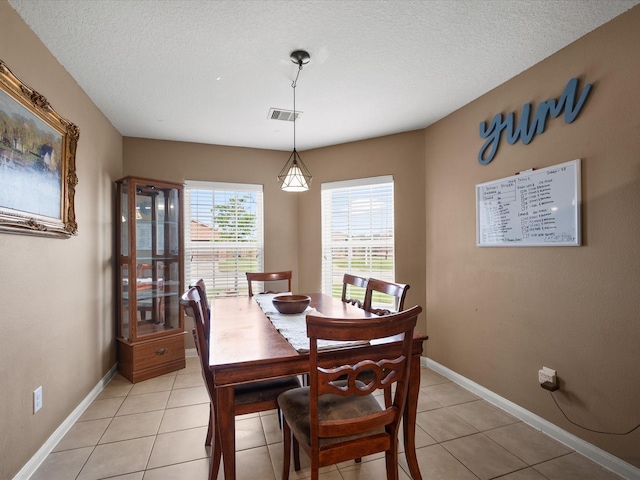 20819 Mount Bauer Dr, Hockley, TX 77447 - dining room with visible vents, baseboards, a textured ceiling, and light tile patterned flooring
