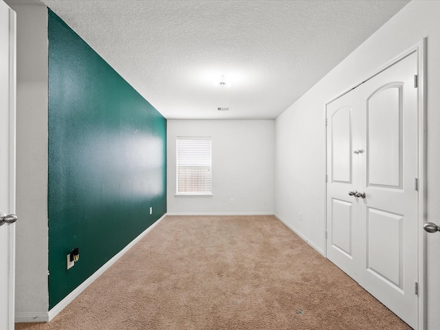 20819 Mount Bauer Dr, Hockley, TX 77447 - empty room with a textured ceiling, carpet flooring, baseboards, and visible vents