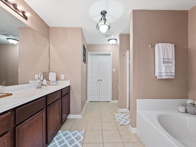 20819 Mount Bauer Dr, Hockley, TX 77447 - bathroom with tile patterned flooring, visible vents, vanity, a bath, and baseboards